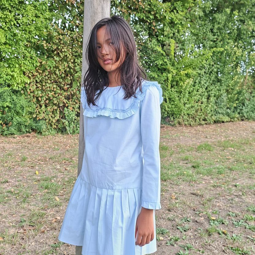 en PRE-COMMANDE. Robe bleu clair avec plastron smockée.